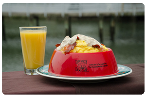 A classic Salty Dog breakfast including eggs, bacon, home fries,
cheese and hollandaise served in a souvenir dog bowl.
